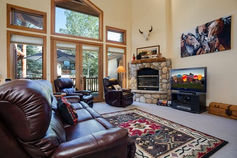 Sink into rich leather seating by your crackling stone fireplace, where rustic charm meets modern comfort for perfect evenings in.