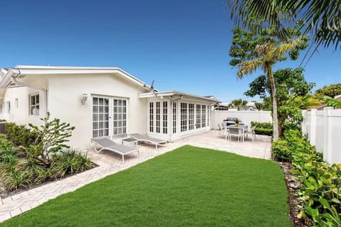 Private backyard patio with lush lawn, outdoor dining area, and plenty of sunshine—perfect for relaxing or entertaining.