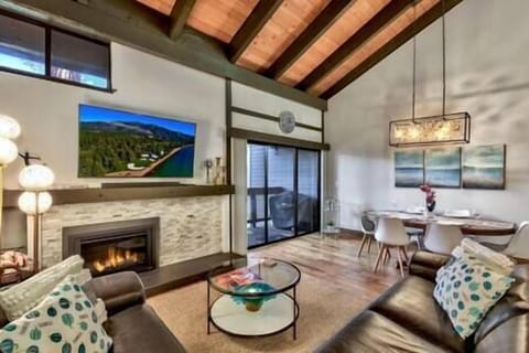 Inviting open concept family room with modern fireplace, flat screen TV and board games (1)