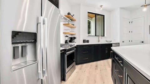 The kitchen has ample storage and stainless steel appliances