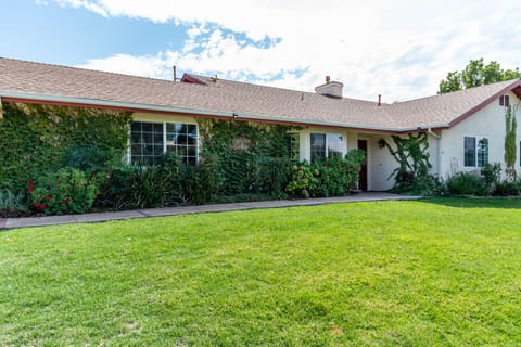 A wide front lawn and climbing ivy give the home strong curb appeal.
