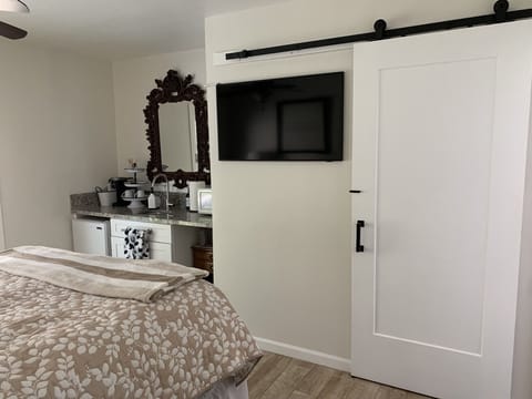 Queen bedroom suite, smart TV,  kitchenette, bathroom behind barn door.