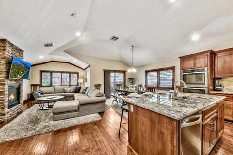 Unwind in your spacious open-concept retreat with granite countertops, cozy fireplace, and chef's kitchen perfect for memorable meals.