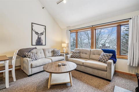 A bright gathering space with mountain-view windows, soft seating, and an easy, relaxed layout that's perfect for unwinding or spending time together after a day on the slopes.