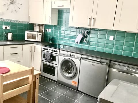 Spacious kitchen with dishwasher, washing machine, freezer and separate fridge.