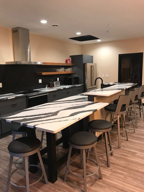 Kitchen island with Cambria counter top has seating for10
