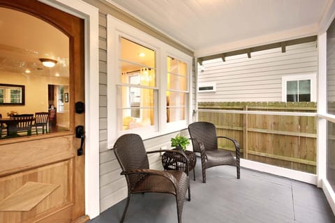 Screened front porch with view of historic Oak. 
