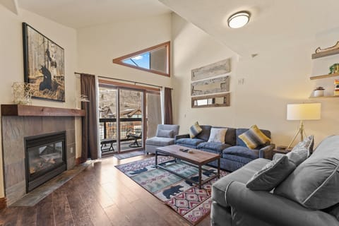 Unwind in your spacious living room with fireplace warmth, mountain views, and cozy seating for memorable evenings together.