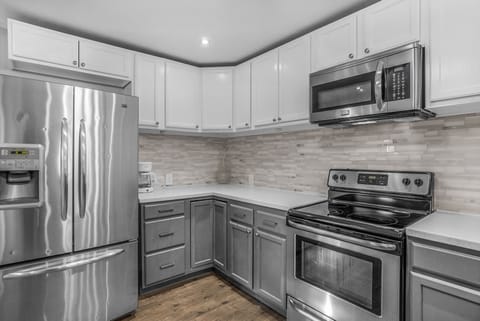 A kitchen with plenty of workspace and equipment.