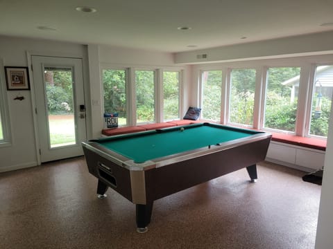 Gameroom featuring free pool with automatic ball return.  There are no curtains.