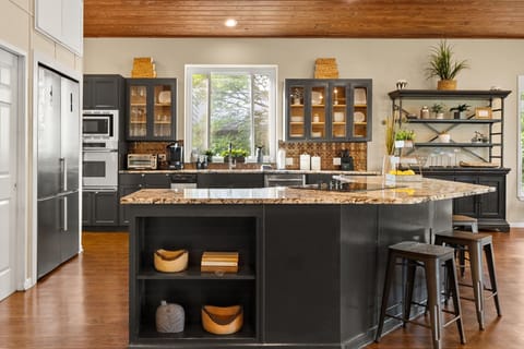 Contemporary kitchen with island and modern appliances.