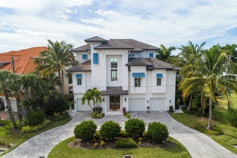 Exterior Front of House with Circle Drive and Plush Landscaping 
