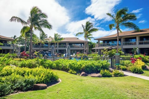 Inviting resort grounds with lush tropical landscaping, swaying palms and vibrant gardens