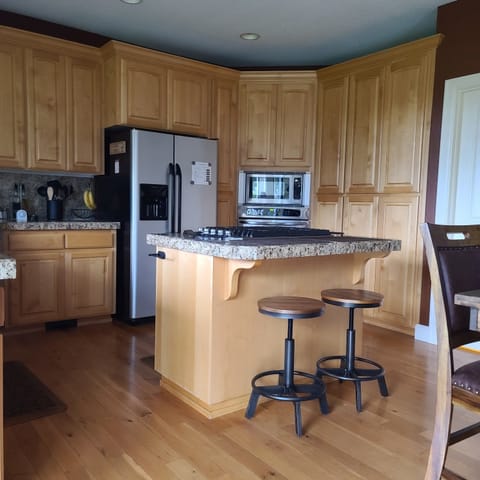 Kitchen with island and two bar stool seating.