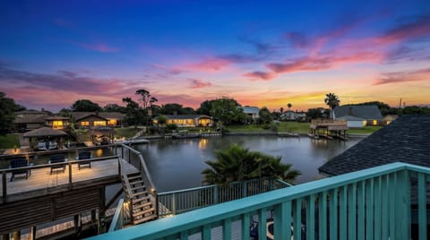 Sunset over Madeline Lake from Lakeview Landing's private dock — moments like this are why guests return to this Galveston waterfront home year after year.