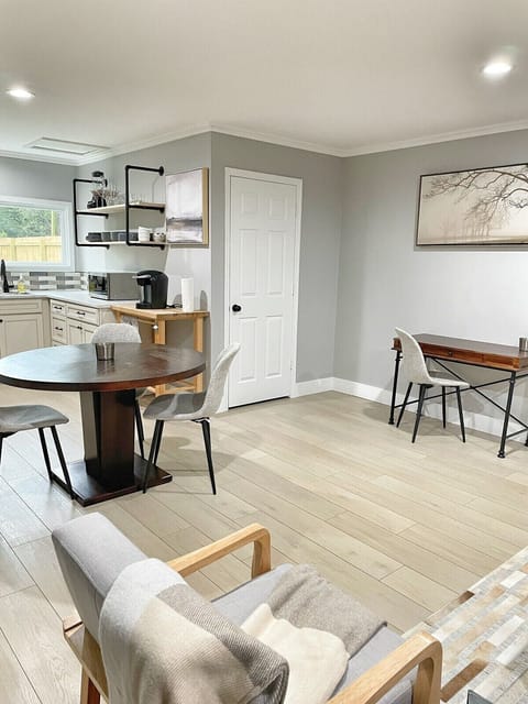 Crisp kitchen view showing layout and entry to the bathroom.