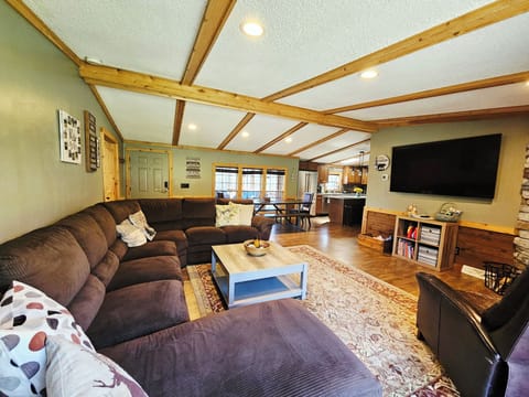 Open Large living area with comfortable couch, 70"  Smart TV 