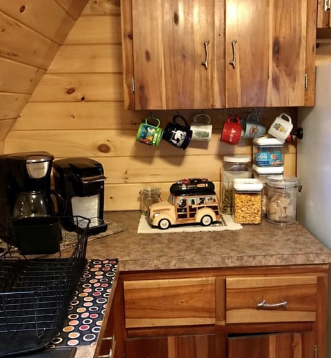 Coffee nook complete with drip coffee maker and Keurig. Condiments provided
