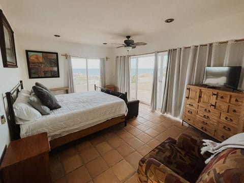 Primary bedroom with king bed, fans, TV, storage and a view