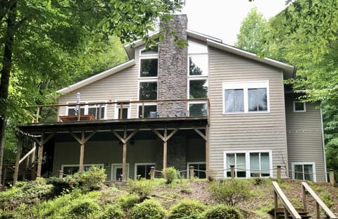Back of home overflowing with views of lake and relaxing area's on both levels
