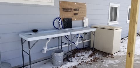 Fish Cleaning Station with running water, fish mats & bags/freezer for disposal.
