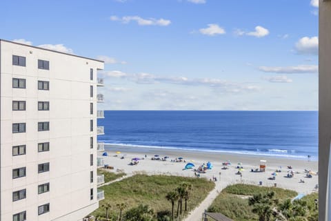 Oceanview balcony overlooking sandy beach and sparkling waves