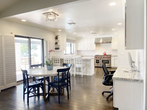 Informal dining/game table plus business center next to the kitchen. 