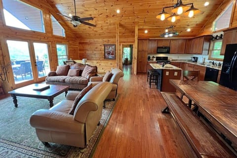The spacious open floor plan at Smoky Mountain High connects the living room, dining area, and full kitchen for easy group gatherings.