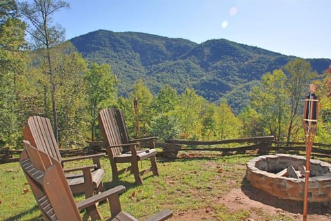 Stone fire pit with seating at A Sunrise in the Smokies cabin in Baines Mountain near Bryson City