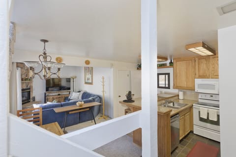 View from stairs looking into kitchen and living room