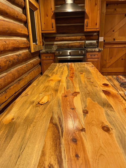 Long kitchen table and Kitchen Aid gas cooking range.