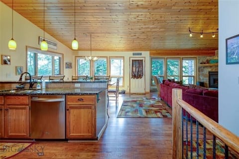 Large open concept living space with kitchen, dining and living room upstairs.