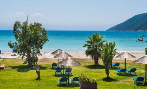 On the beach, black sand, sun loungers, beach umbrellas