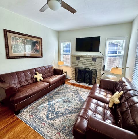 Open-concept living and dining area featuring a cozy electric fire.
