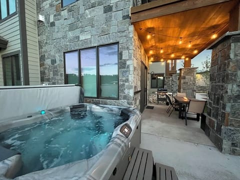 Private hot tub- enjoy the beautiful ambiance of the patio with fire pit table