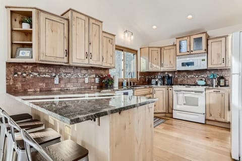 (Main level) Beautifully appointed kitchen and bar with 4 bar stools.