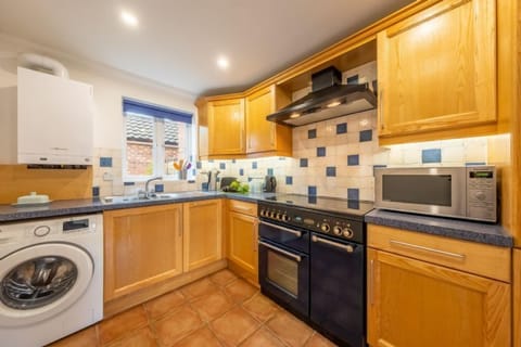 Ground floor: Kitchen with gas Rangemaster, microwave, slimline dishwasher, fridge-freezer and washing machine