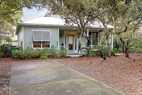 Tucked beneath shady trees, this charming coastal cottage welcomes you with open arms.