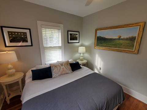Primary bedroom features a king bed with a ceiling fan