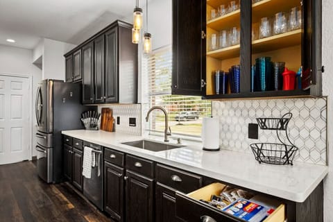 Fully equipped kitchen with ample cabinetry, modern finishes, and everyday essentials—ideal for cooking and group meals.