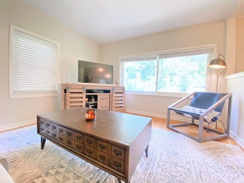 A living space with plenty of seating and newly added curtains for comfort!