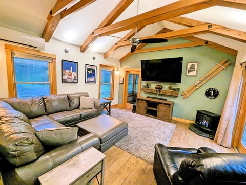 Living Room w/75" smart TV, leather sofa, gas stove