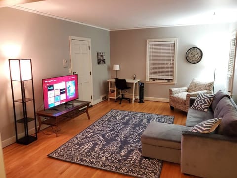 Living Room w/sectional sleeper, desk, two closets, ceiling fan, chair and Roku TV