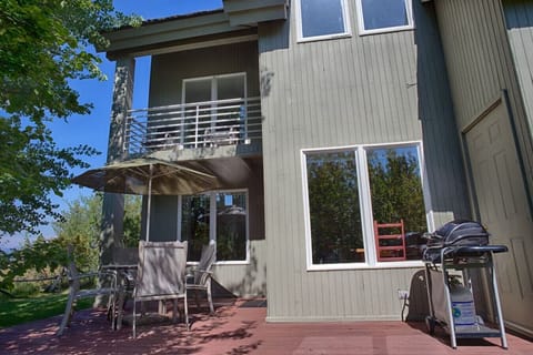 Back deck with grill and outdoor seating in summer