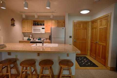Kitchen with extra seating at bar feat. entryway