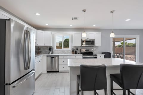 Fully stocked w/ All Clad pots & pans and utensils for all your cooking needs!