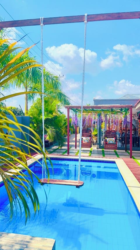 Infinity swimming pool with hanging swing