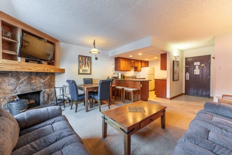 Relax in your spacious living area with cozy fireplace, fully equipped kitchen, and dining space—perfect for unwinding after mountain adventures.
