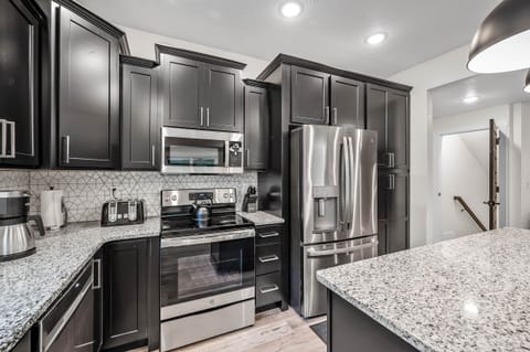 Main level kitchen refrigerator equipped with water and ice maker