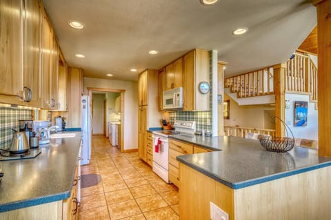 Huge kitchen and laundry space, wet bar, and grilling patio are easy access on this main floor. Carafe style coffee pot, and service for all 12 guests